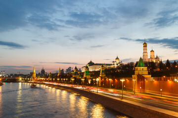Obraz premium The Moscow Kremlin in sunset. Bell tower. Embankment. Car traces