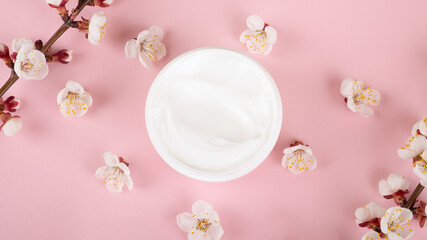 cream and flowers on pink background,beauty skin care cosmetic.