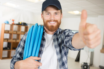 a plumber is showing a thumb up