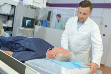 Fototapeta premium radiologist adjusting xray machine over man