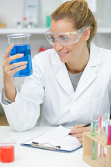 Fototapeta premium female worker with liquids in lab