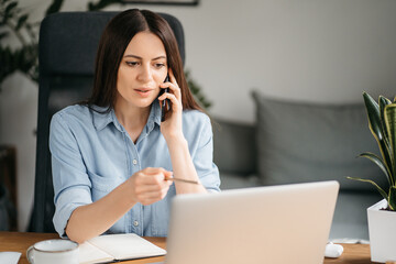 Head shot pleasant happy young woman freelancer working on computer at home. Attractive...