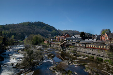 Fototapeta na wymiar a flowing river next to a train station