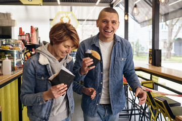 young couple eating breakfast in fast food