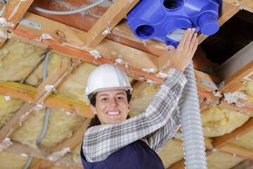 a female worker is working with pipes