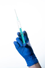 doctor wearing gloves holding syringe