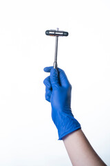 doctor wearing blue gloves holding reflex hammer