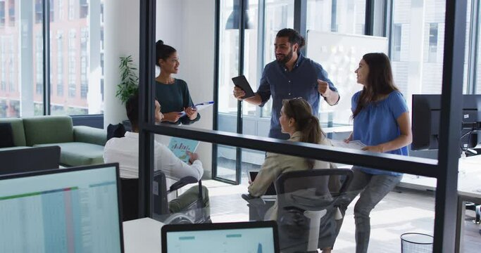 Diverse group of happy work colleagues talking at casual office meeting