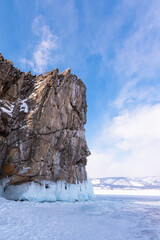 Ice-covered Ogoy Island in the Maloye More Bay of Lake Baikal in winter. Siberia, Russia.