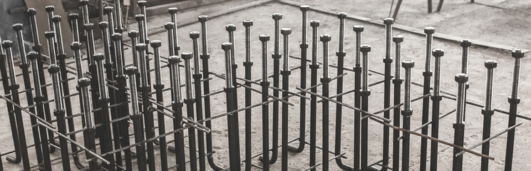 Metal anchor bolts for concrete construction structures, foundation on the background of the...