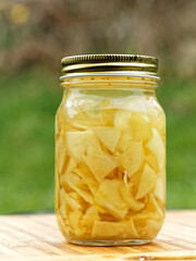 Sliced ginger pickling in the glass jar, close-up