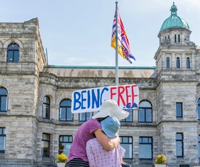 Mom hugging daughter during freedom protest