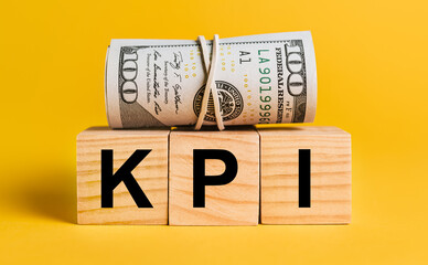 KPI with money on a yellow background. The concept of business, finance, credit, income, savings, investments, exchange, tax