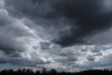 Obraz na płótnie Canvas Dramatic sky with dark clouds lit by sun