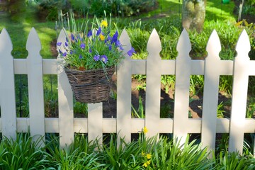 white picket fence with hanging flower basket decoration