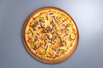 pizza with green pepper and smoked sausage view from top
