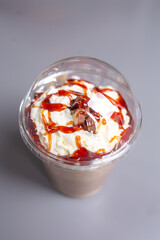 milkshake with caramel in a plastic cup