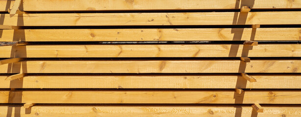 Planks (wood) for construction, stacked.