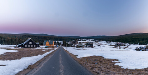 Wooden buildings in Jizerka small village before cold fresh color sunrise