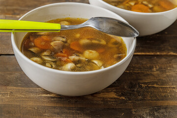 homemade champignon soup in a ceramic bowls on a wooden table