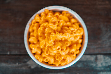 Macarrones con queso. Plato tradicional americano pasta de macarrones y salsa de queso con mano