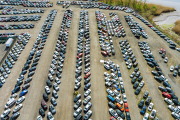 Many cars parked distributed in used car auction lot