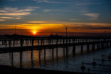 Sunset behind empty wooden piers..