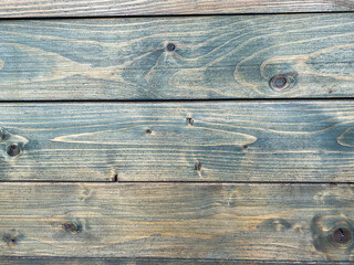 Beautiful wooden texture of horizontal multi-colored boards with knots on the wall surface. The background. Texture
