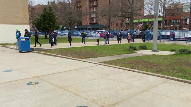 Pan View of People Standing in Line Waiting for Their Covid Vaccination Shot