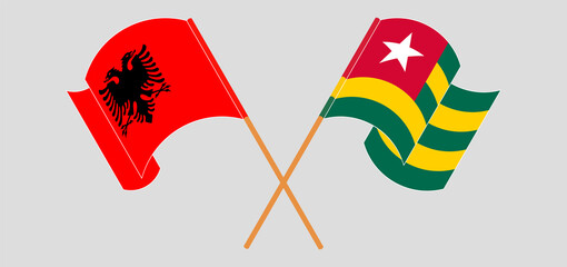 Crossed and waving flags of Albania and Togo