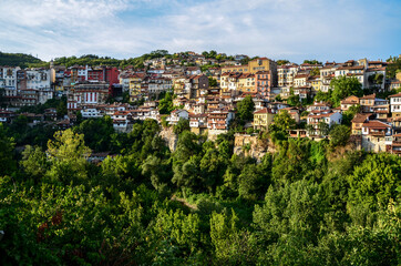 Fototapeta na wymiar Beautiful view over the old town with a traditional architecture of Veliko Tarnovo on a summer day at sunset. Bulgaria