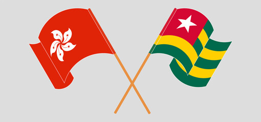 Crossed and waving flags of Hong Kong and Togo