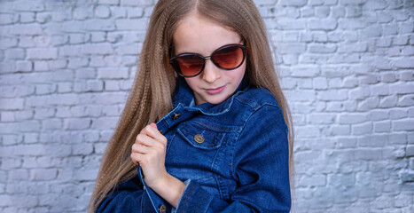 Emotional girl in blue denum jacket looking to the camera.