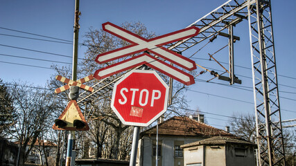 Traffic signs in front of a railroad crossing intersection