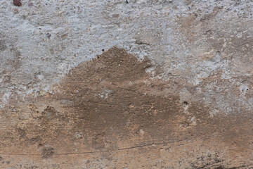 Old, cracked foundation cement, with holes, scratches, sand and white paint residue.