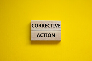 Corrective action symbol. Wooden blocks with words 'Corrective action' on beautiful yellow background. Business and Corrective action concept. Copy space.