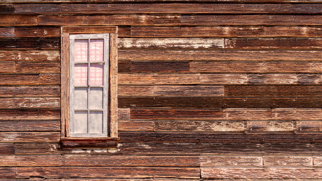 Old western style rustic wooden exterior wall with a framed window