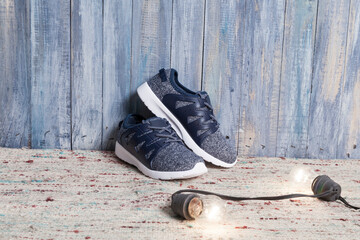 Kids fashion - children's sports shoe photo on wooden background.