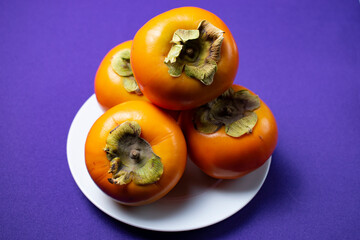 persimmon fruit on a plate