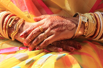 Beautiful decorated married woman's hand wearing ornaments and jewellery, close and cropped view.
