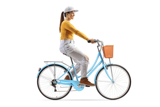 Full length profile shot of a young female riding a blue city bicycle