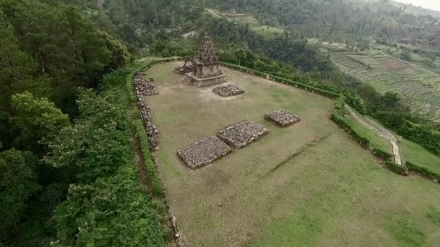 Beautiful isolated hindu temple in the green hill landscape aerial footage view