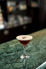 cocktail with coffee beans and froth stands on the bar