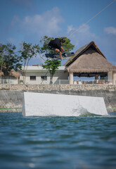 man jumping on a wakeboard over the water