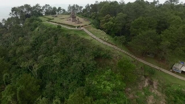 Beautiful Hindu temple aerial footage dolly shot view in top of hill. Shot from drone flying backward slowly