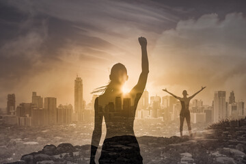 Strong confident woman flexing arms facing the city sunset. People feeling inspired, and having...