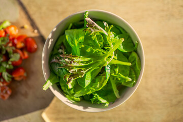 Bowl of salad on wooden table
