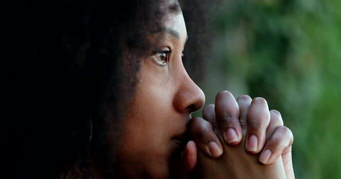 Black African woman praying to God seeking solution to problems