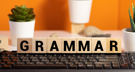 GRAMMAR text on a wooden background, concept