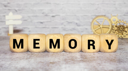 gray word memory from small wooden letters on a blue table.